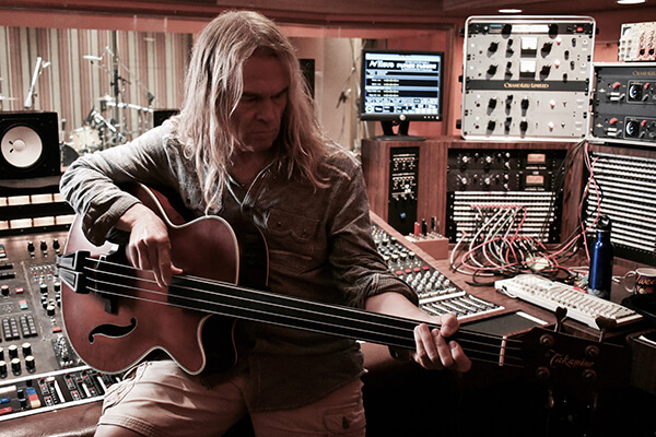 Tony Franklin playing his Takamine accoustic guitar